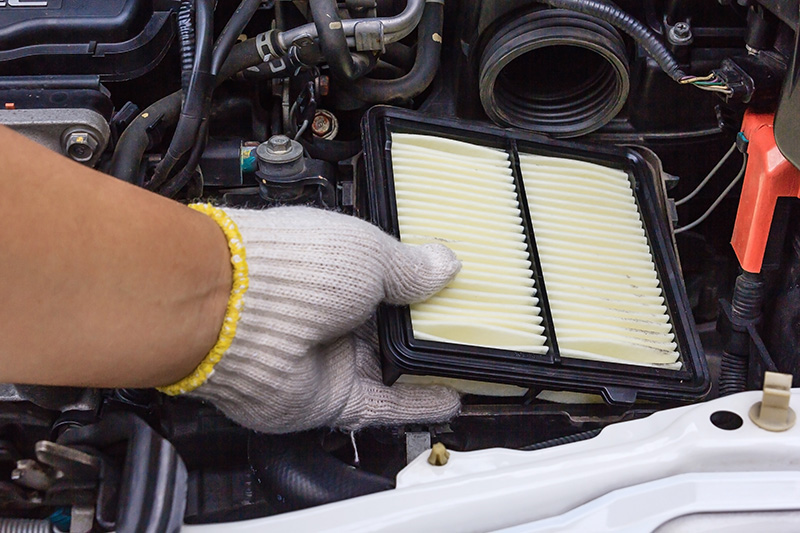 Mechanic replacing air filter