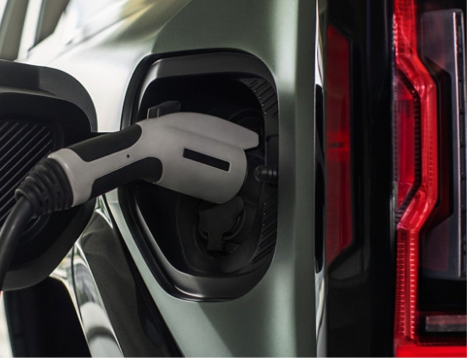 Close up of charging port with charger plugged in on a GMC Hummer EV SUV - Neuville Motors GMC in Waupaca WI