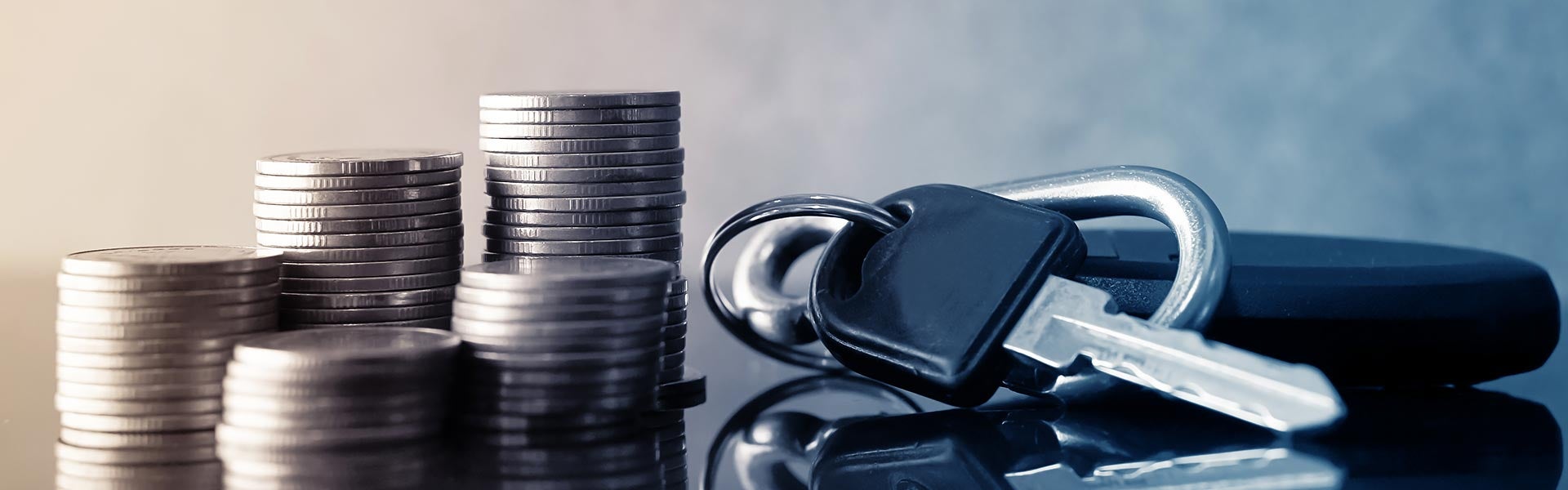 A new set of GMC keys and stacks of coins on a table